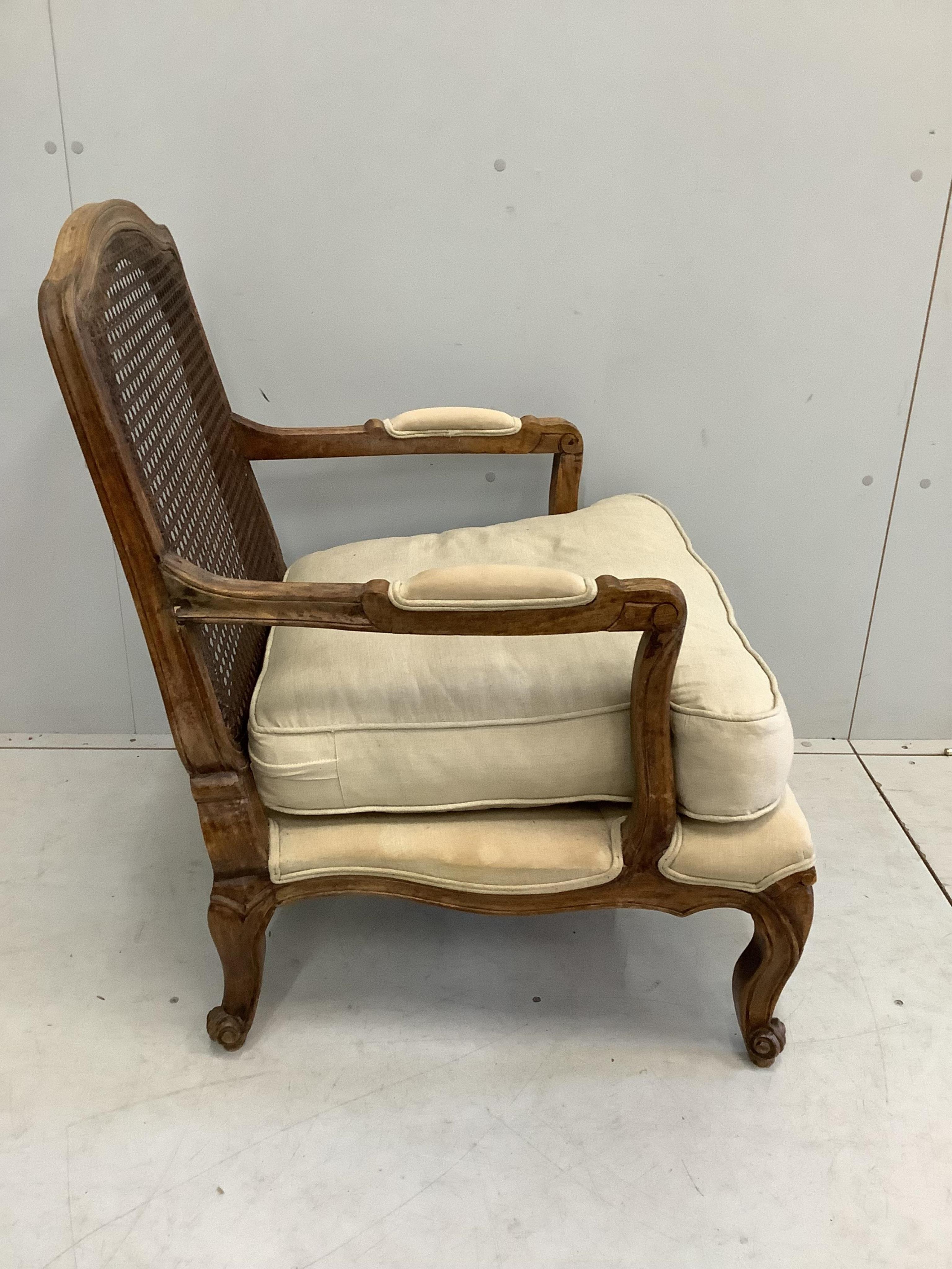 A Louis XVI style caned back beech armchair, width 64cm, depth 64cm, height 87cm
